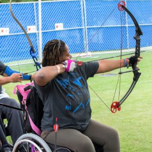 woman in wheelchair shooting archery
