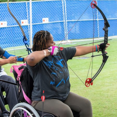 woman in wheelchair shooting archery