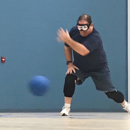 Goalball athlete standing and throwing the ball