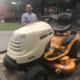 large riding lawn mower with man, Jeff Braddy from Latta Brothers, standing behind it.