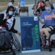 teen boy and teen girl sitting in sport wheelchairs waving wearing masks. a sign between them reads 'You are Unstoppable' Ablilty Equipped The Hartford