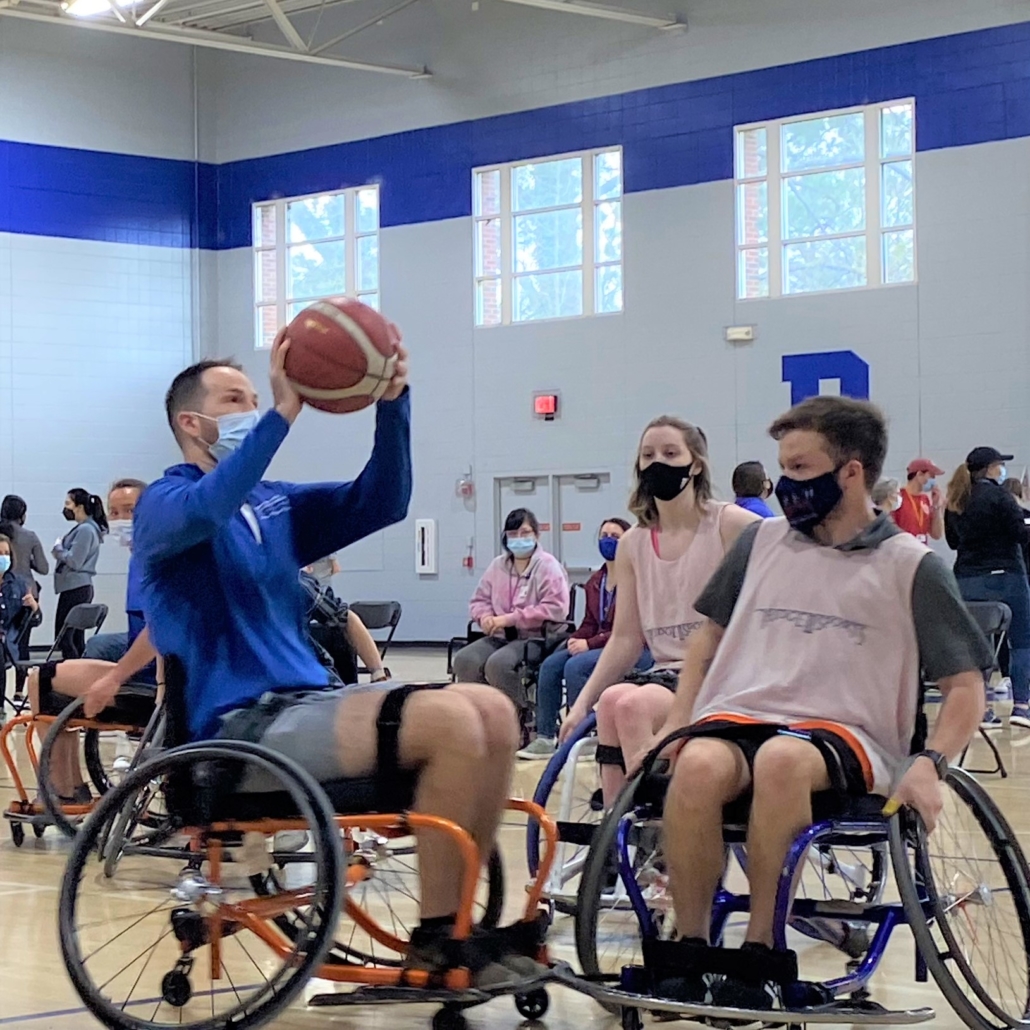 duke student shoots basketball during game of wheelchair basketball